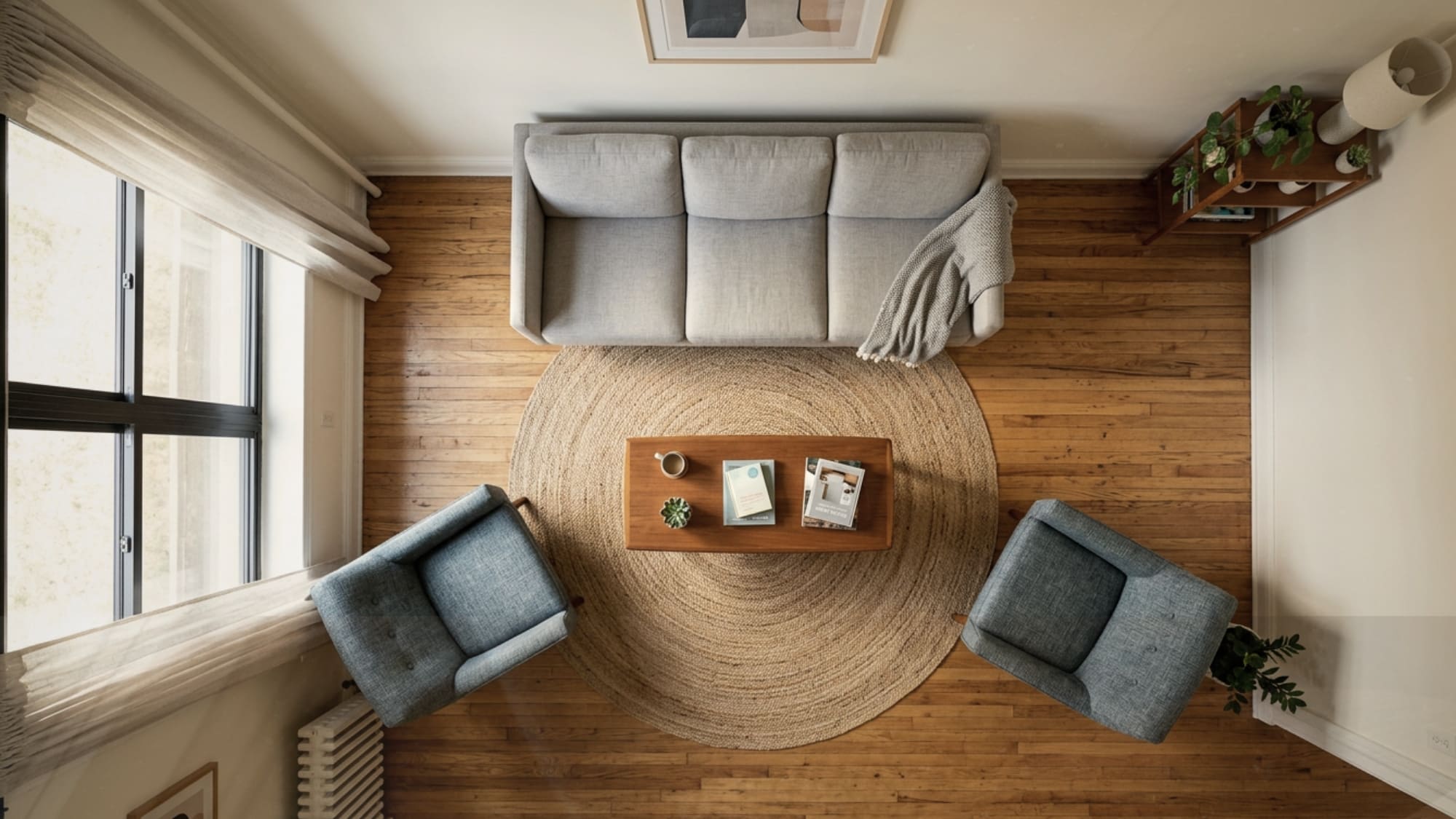 Sofa and chairs floated away from the walls in a small living room with visible floor gaps creating breathing room