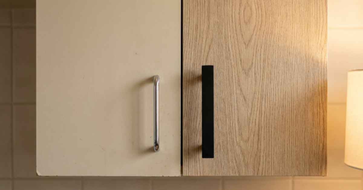 Rental kitchen cabinet door before and after — original beige laminate with chrome pull on the left, light oak grain contact paper with matte black bar pull on the right